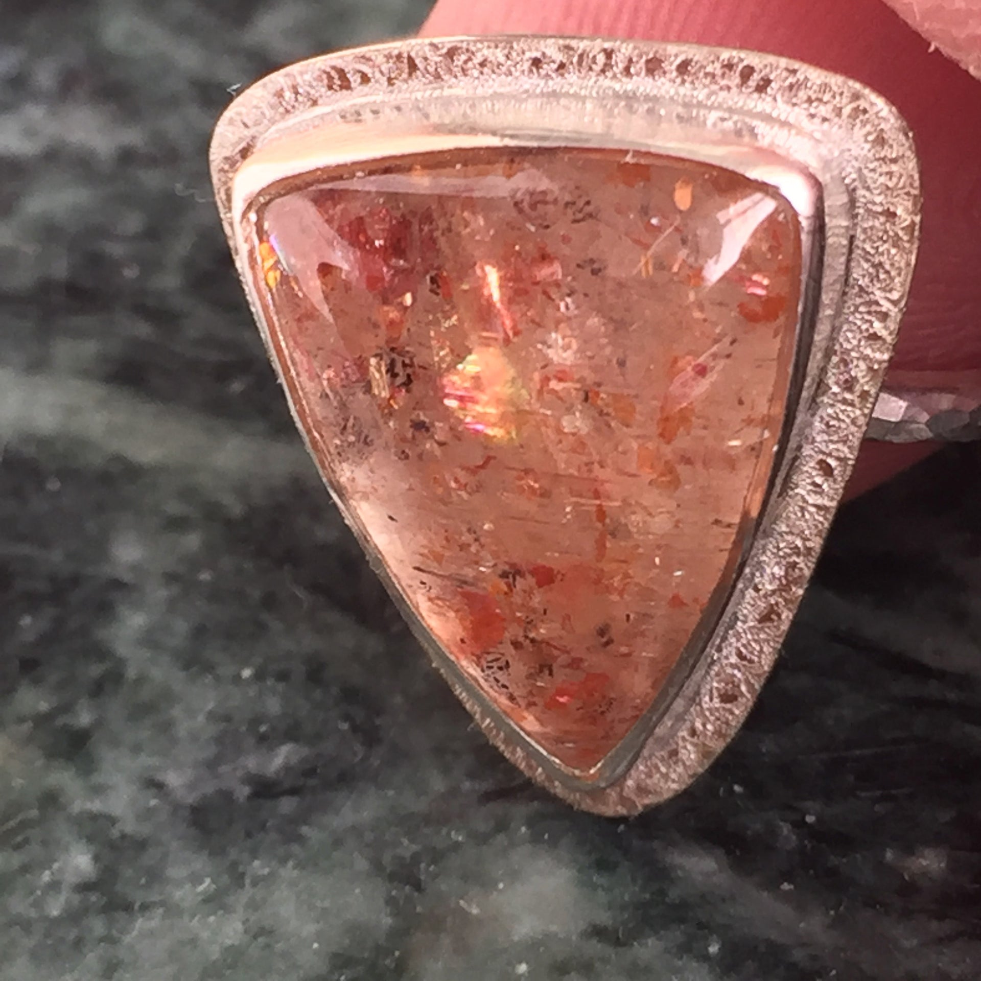 Load video: sped up video of Katie setting a stone into a bezel set silver ring